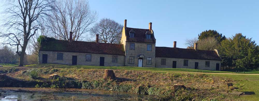 The Alms Houses at Great Linford with the school house in the centre.